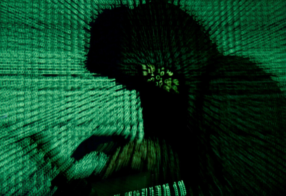 FILE PHOTO: A man holds a laptop computer as cyber code is projected on him in this illustration picture taken on May 13, 2017. Capitalizing on spying tools believed to have been developed by the U.S. National Security Agency, hackers staged a cyber assault with a self-spreading malware that has infected tens of thousands of computers in nearly 100 countries. REUTERS/Kacper Pempel//File Photo