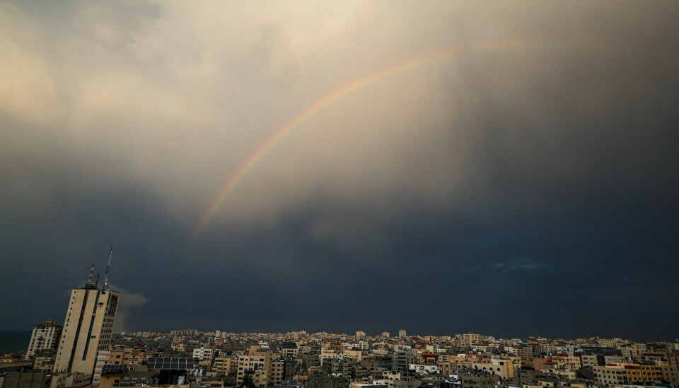 A rainbow appears in the sky over Gaza City on October 9, 2023. The death toll from the unprecedented assault by Palestinian militant group Hamas on its territory rose to 900 in Israel, which has retaliated with a withering barrage of strikes on Gaza, raising the death toll there to 687. (Photo by Mahmud Hams / AFP)