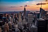 Panoramic view of Manhattan skyscrapers with the Empire State Building at sunset.