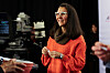 Mary Peltola in an orange jumper speaks with attendees at an Anchorage debate event.